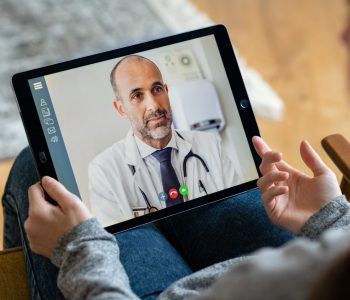doctor and patient communicating on a tablet
