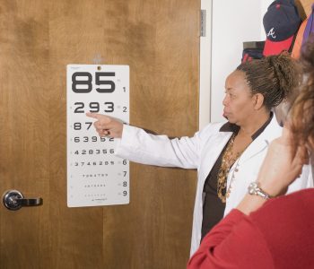 woman performing eye exam
