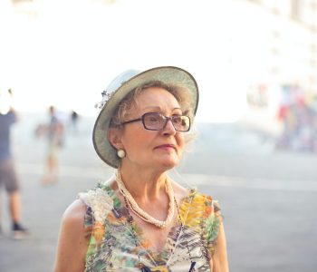 Woman in Pastel Color Shirt and White Sunhat